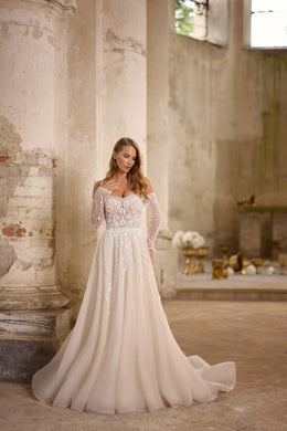 Sparkling ivory A-line wedding dress with a sweetheart neckline, sheer long sleeves, and a sweeping train