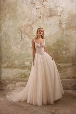 Ivory A-line wedding dress with a sweetheart neckline, beaded bodice, and sparkling floor-length skirt