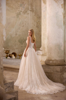 Lace-up back and sweeping train on a sparkling ivory A-line wedding dress