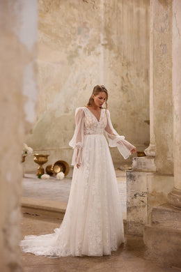 Ivory A-line wedding dress with a plunging V-neckline, lace bodice, bishop sleeves, and train