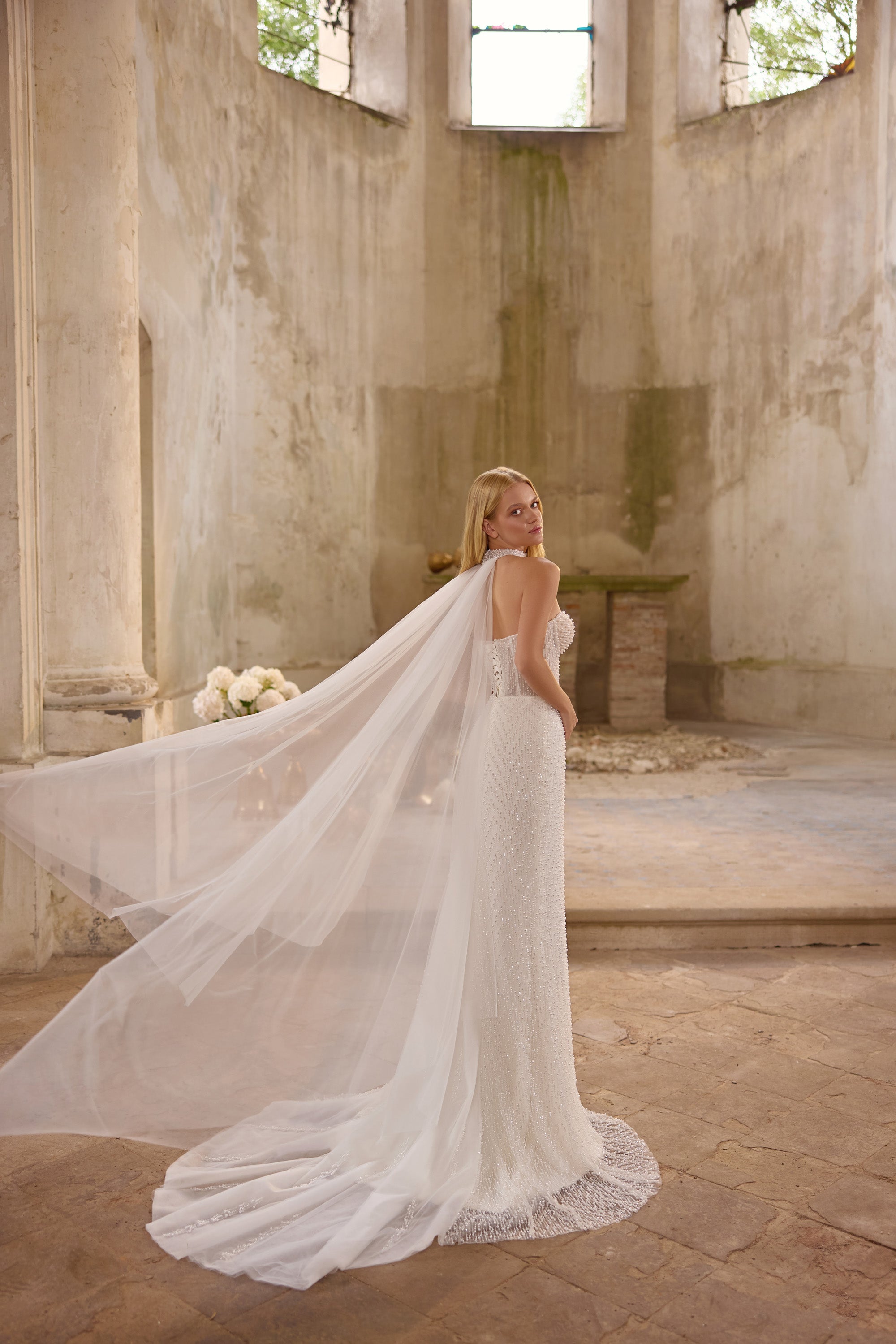 Romantic lace wedding dress featuring a sparkling embroidered corset, detachable overskirt, elegant off-the-shoulder straps, matching choker, and dramatic thigh-high slit.