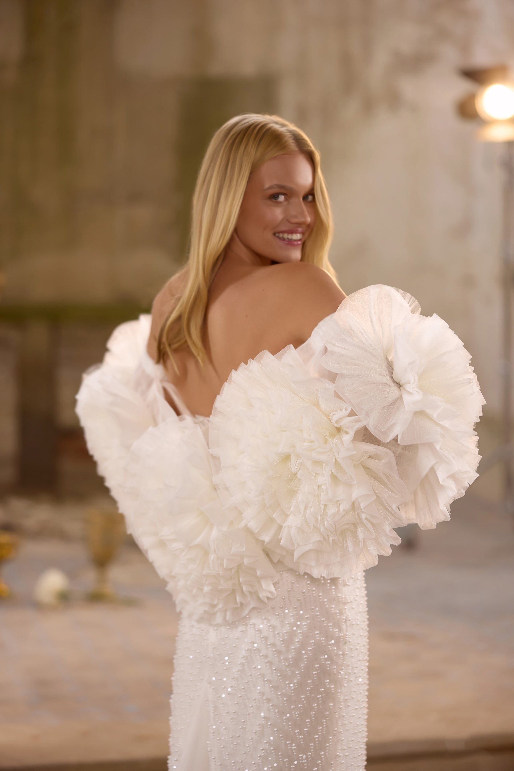 Romantic lace wedding dress featuring a sparkling embroidered corset, detachable overskirt, elegant off-the-shoulder straps, matching choker, and dramatic thigh-high slit.