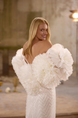 Romantic lace wedding dress featuring a sparkling embroidered corset, detachable overskirt, elegant off-the-shoulder straps, matching choker, and dramatic thigh-high slit.