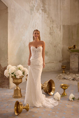 Strapless sweetheart wedding dress with a fitted mermaid silhouette, shimmering beadwork, and train