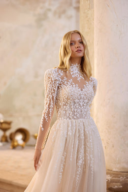 Close-up of floral lace and sparkling beadwork on the high-neck bodice of an ivory wedding dress