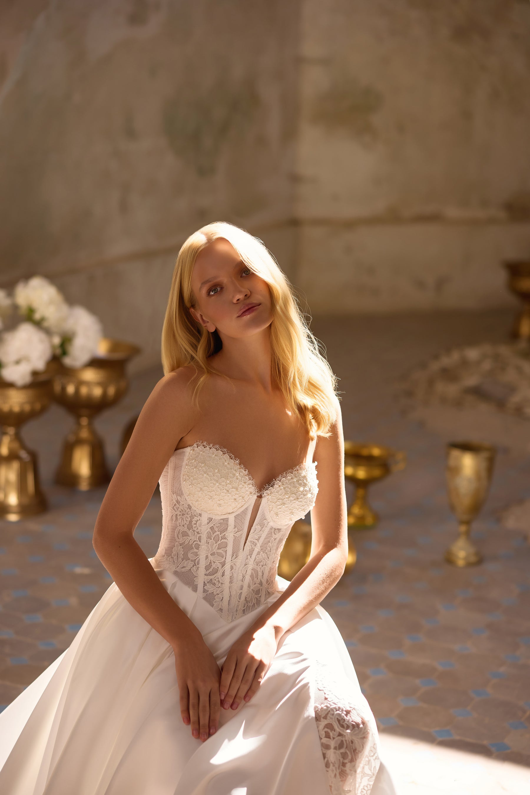 Ivory wedding dress with a strapless sweetheart bodice, lace corset panels, and full skirt