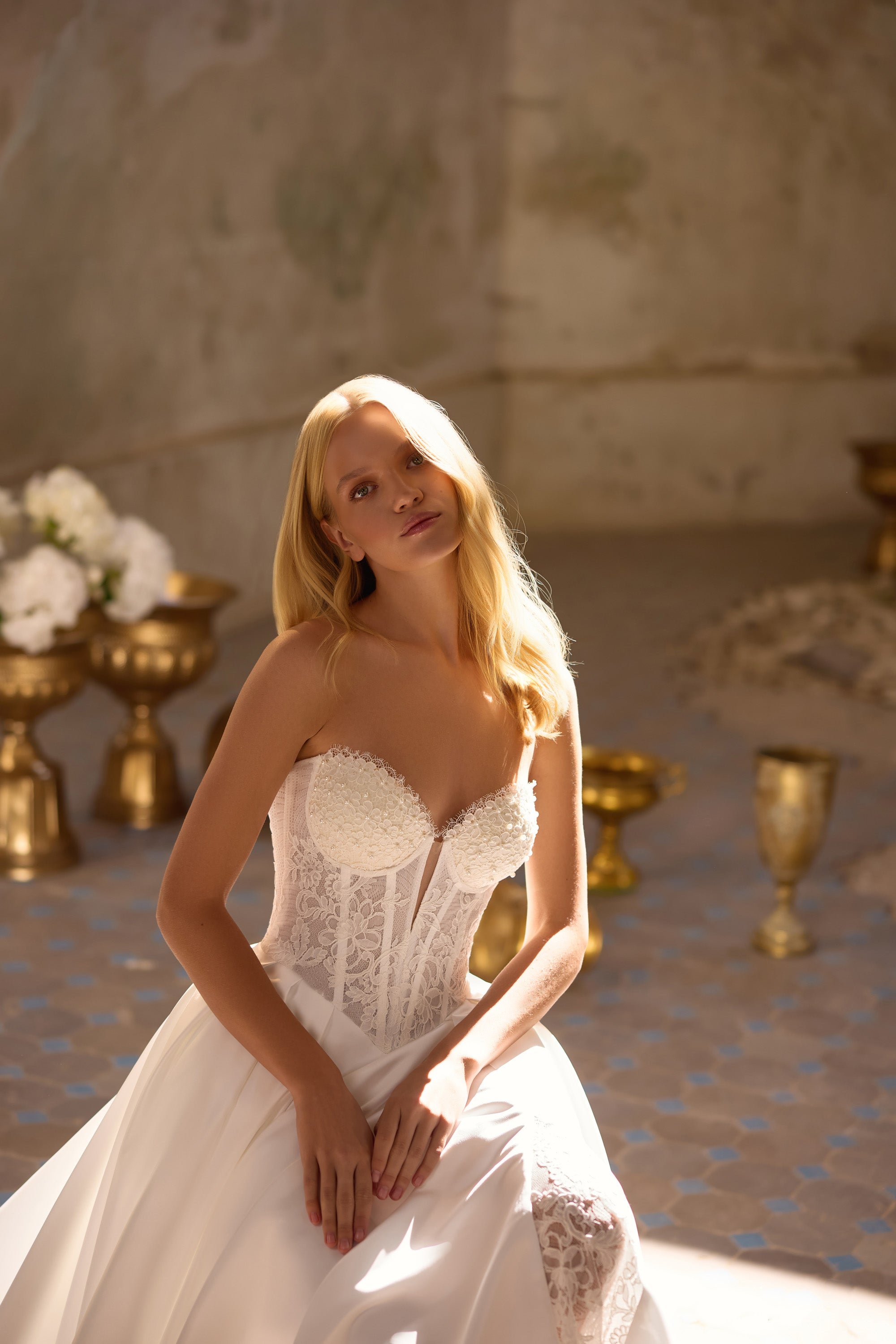 Ivory wedding dress with a strapless sweetheart bodice, lace corset panels, and full skirt