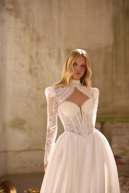 Ivory wedding dress featuring a high-neck lace bolero, keyhole neckline, and structured A-line skirt