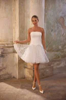 Strapless ivory wedding dress with a glittering flared mini skirt and fitted waist