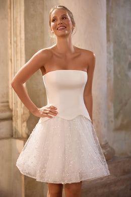 Strapless ivory wedding dress with a fitted bodice and sparkling flared mini skirt