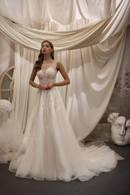 Ivory A-line wedding dress with a sleeveless beaded bodice, rounded neckline, and full flowing skirt