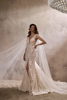 Floral lace wedding dress with a plunging V-neckline, thigh-high slit, and flowing detachable cape