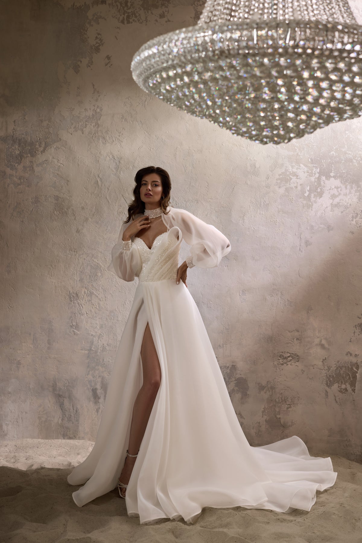 Ivory wedding dress with sheer puff sleeves, a thigh-high slit, and a long flowing train