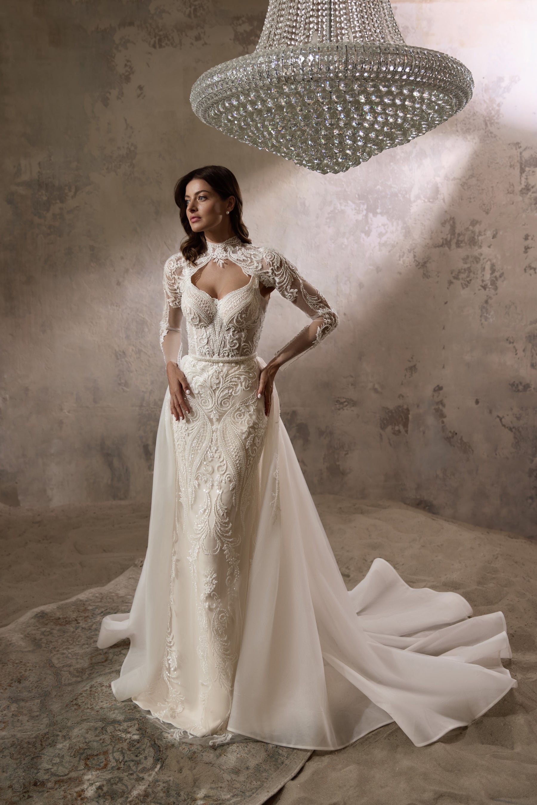 Ivory wedding dress with a lace long-sleeve bolero and flowing detachable overskirt with train