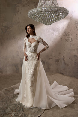 Ivory wedding dress with a lace long-sleeve bolero and flowing detachable overskirt with train