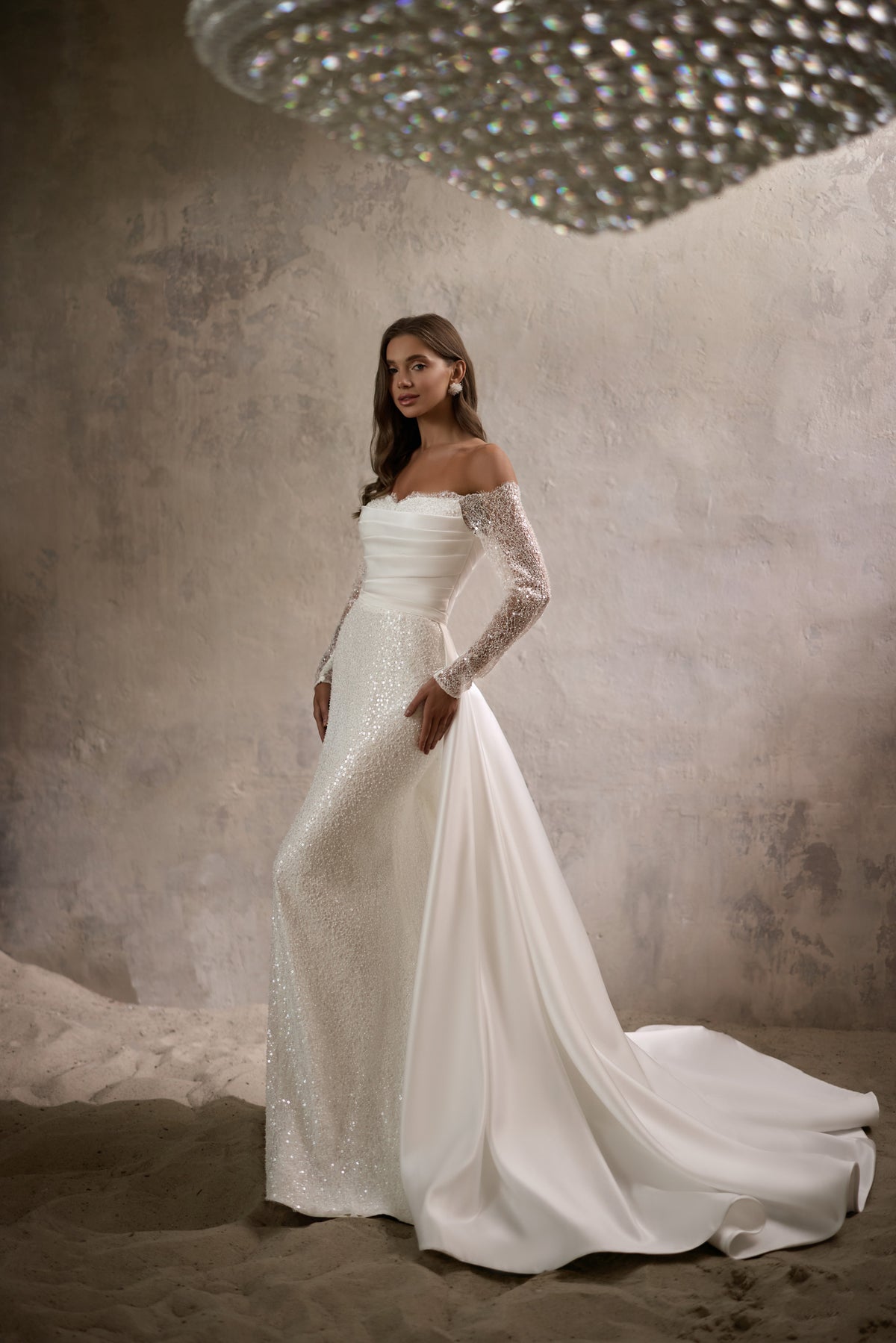 Ivory mermaid wedding dress with off-the-shoulder beaded sleeves and a long flowing train