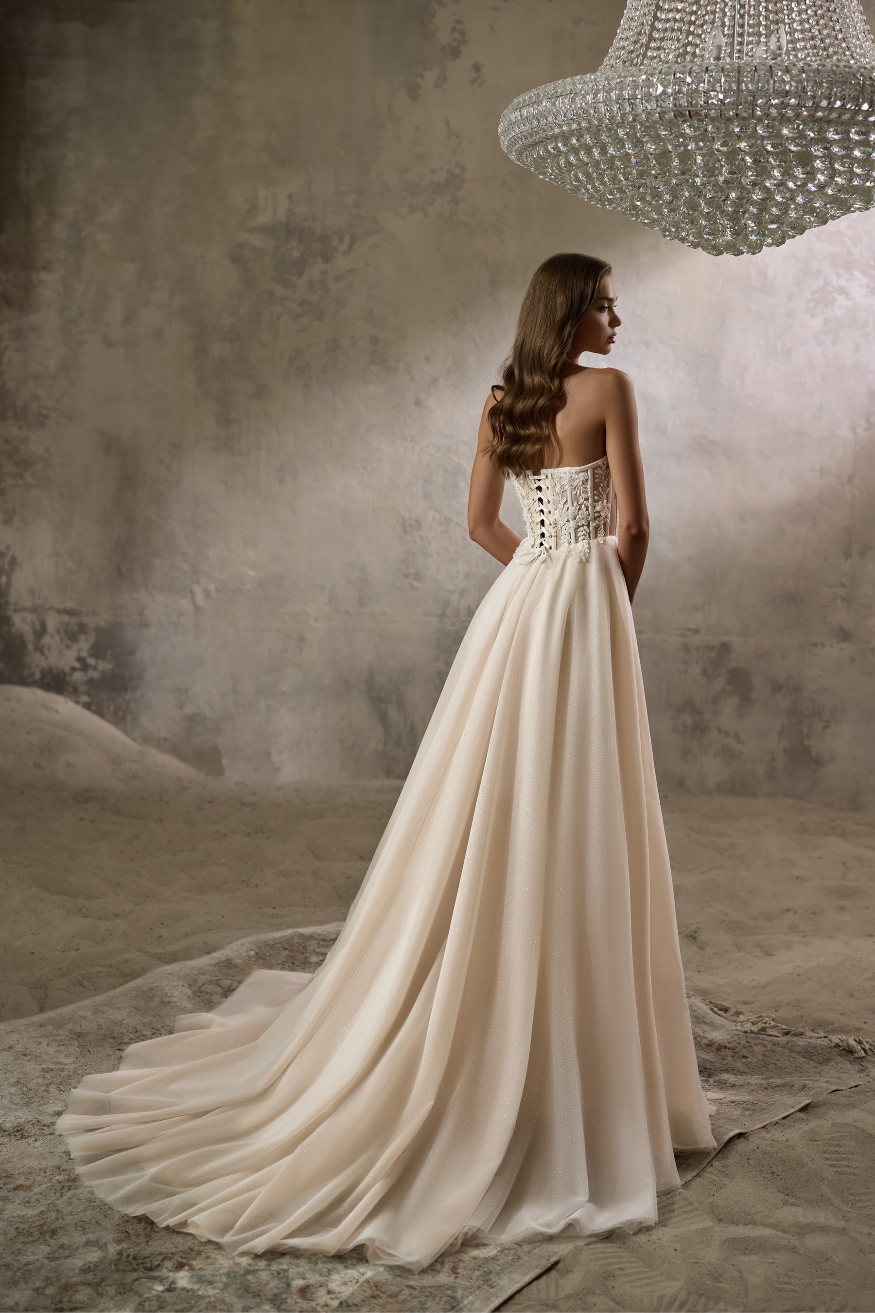 Lace-up corset back and sweeping train on an ivory A-line wedding dress