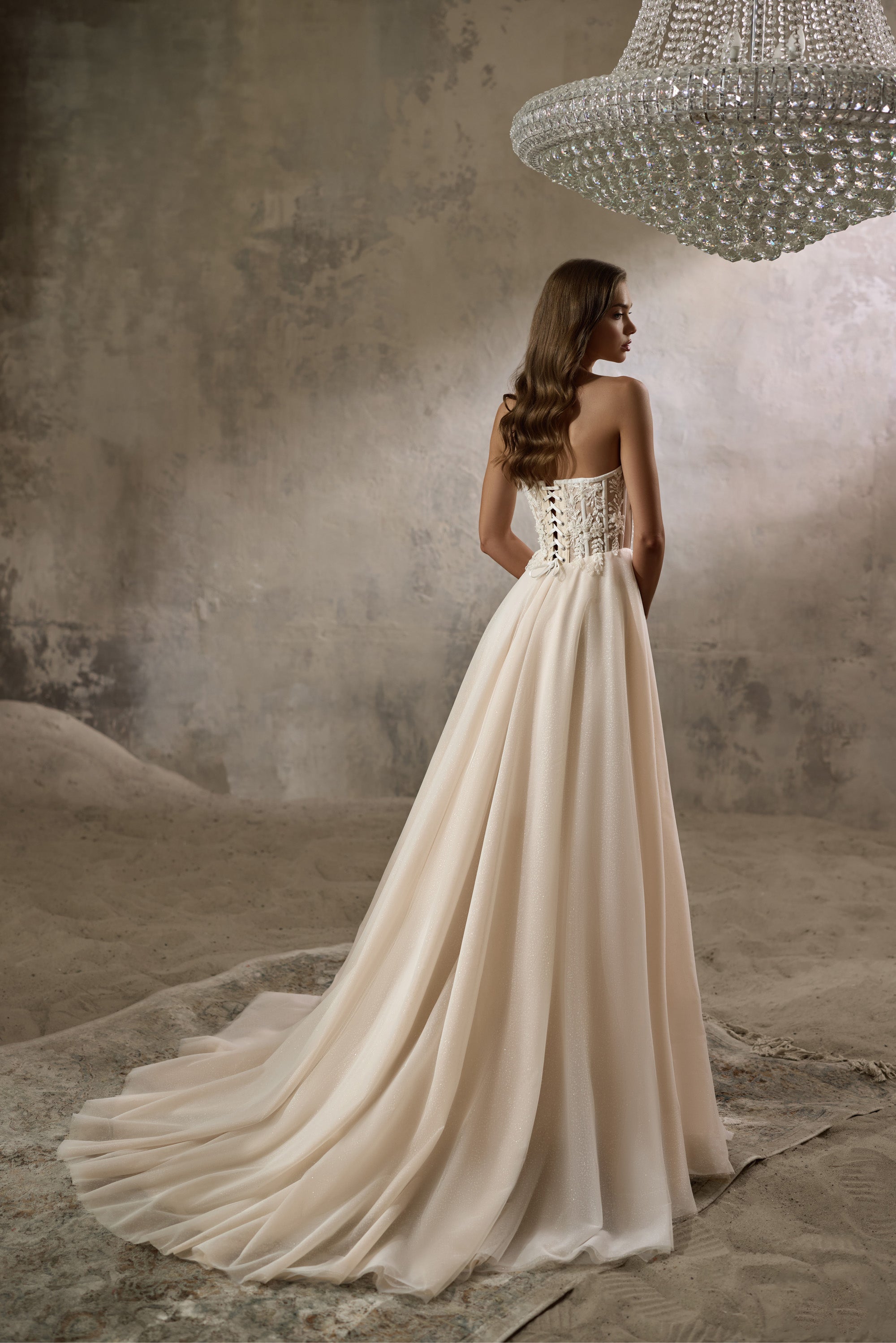 Lace-up corset back and sweeping train on an ivory A-line wedding dress