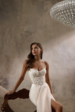 Close-up of floral beadwork on the corset bodice of an ivory wedding dress