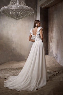 Open-back ivory wedding dress with 3D floral shoulder details, a flowing A-line skirt, and long train