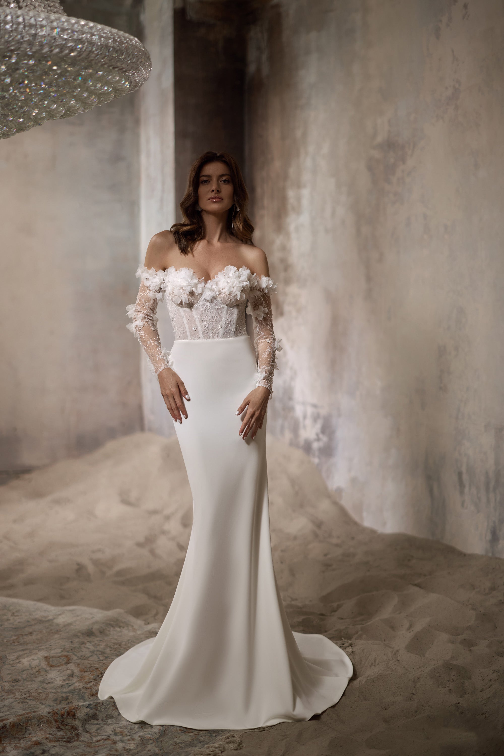 Ivory sheath wedding dress with 3D floral off-the-shoulder sleeves, fitted bodice, and sweeping train
