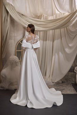 Ivory wedding dress with a sheer floral lace back, draped sleeves, and a long flowing train