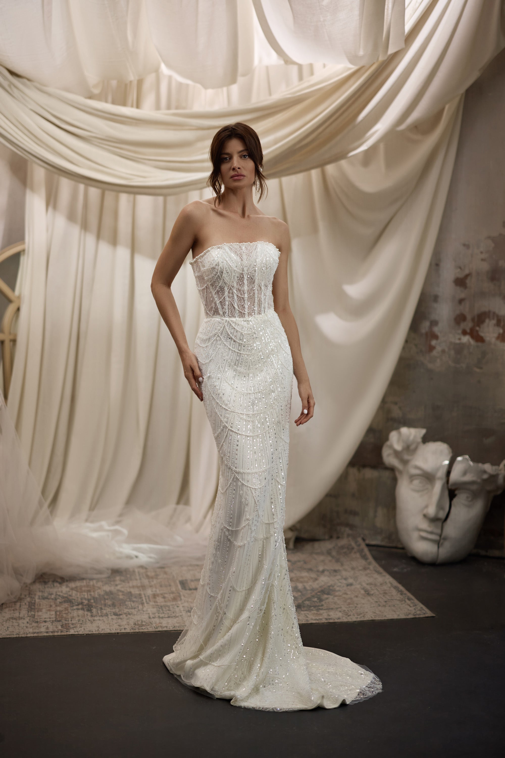 Ivory beaded sheath wedding dress with a straight strapless neckline and slim train