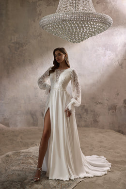 Ivory A-line wedding dress with long illusion lace sleeves, thigh-high slit, and flowing train