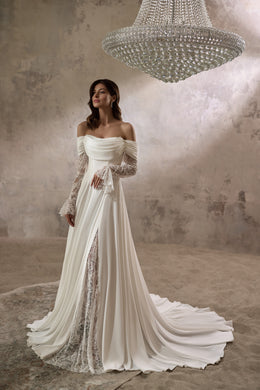 Ivory A-line wedding dress with an off-the-shoulder draped neckline, lace sleeves, and a long train