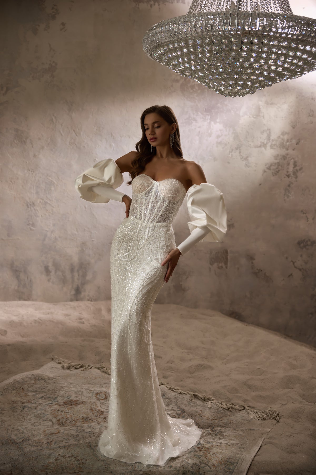 Strapless ivory mermaid wedding dress with sparkling beadwork, detachable puff sleeves, and a long train