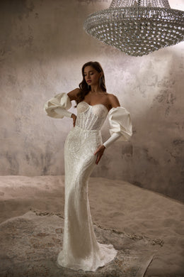 Strapless ivory mermaid wedding dress with sparkling beadwork, detachable puff sleeves, and a long train