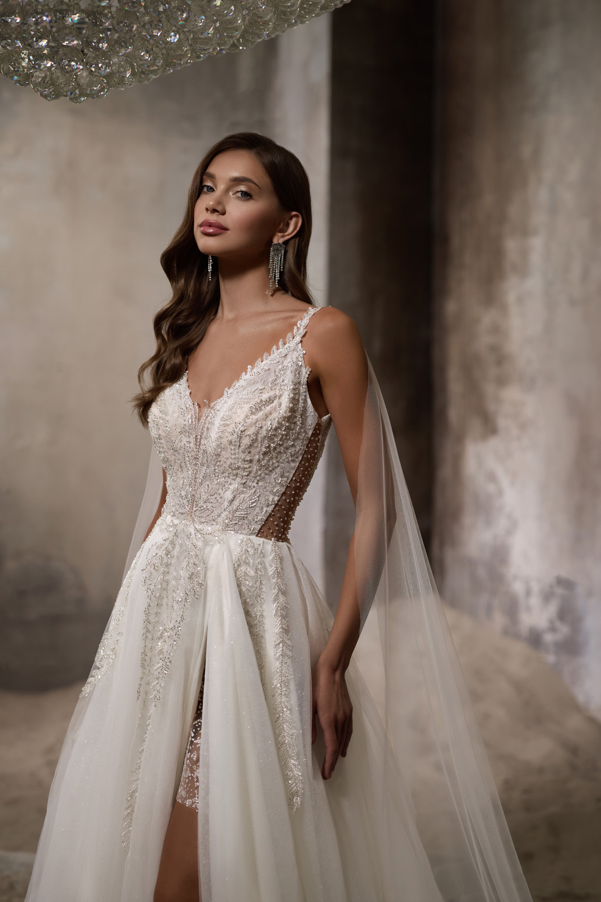 Ivory wedding dress with sparkling beaded V-neck bodice, sheer side panels, and high front slit