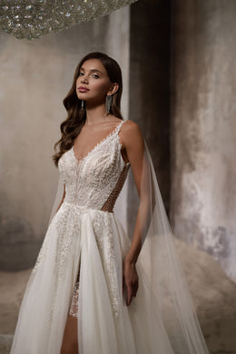 Ivory wedding dress with sparkling beaded V-neck bodice, sheer side panels, and high front slit