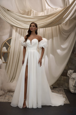 White wedding dress with detachable puff sleeves, beaded sweetheart neckline, high slit, and long train
