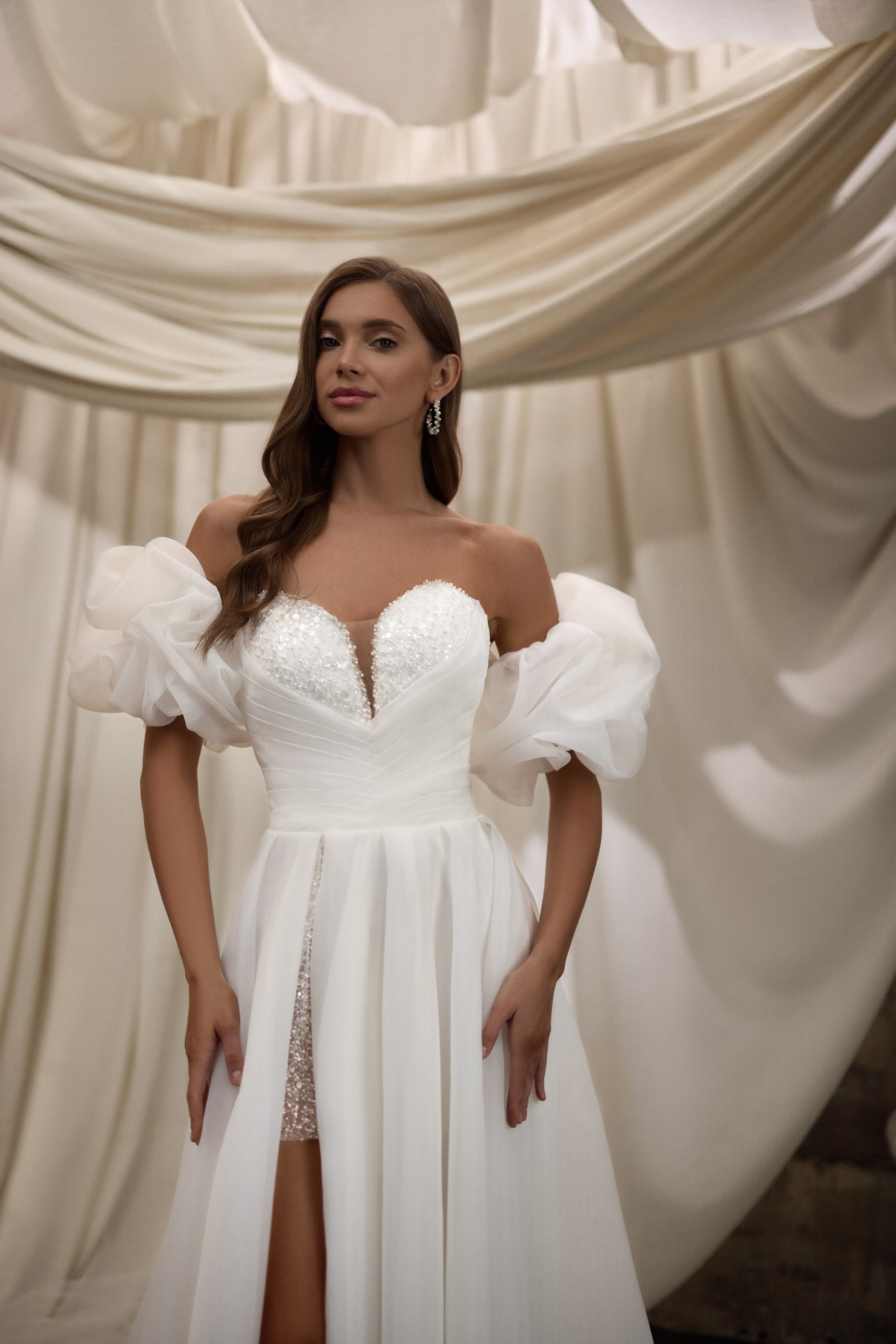 Beaded sweetheart wedding dress with voluminous puff sleeves and a high slit with lace detailing