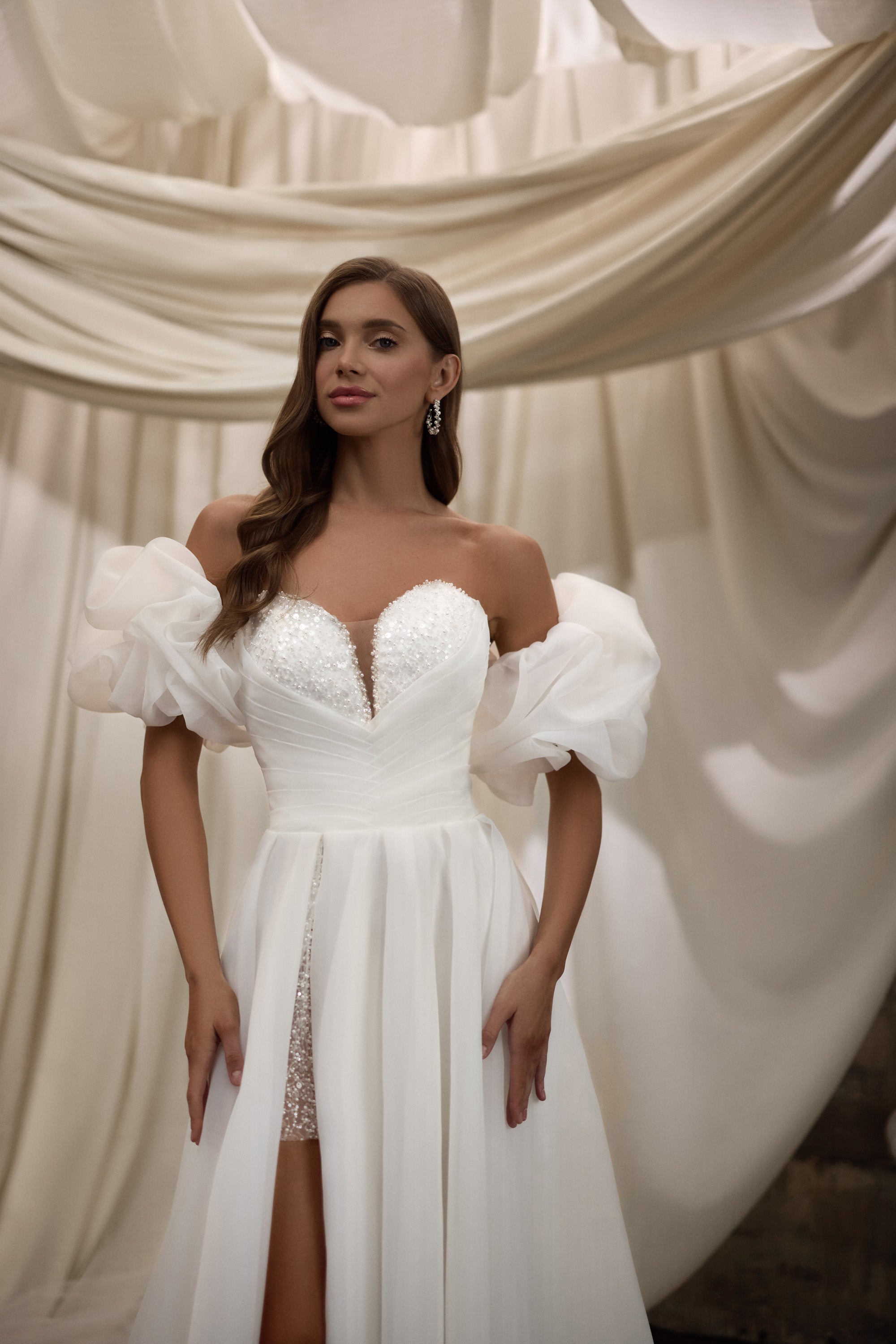 Beaded sweetheart wedding dress with voluminous puff sleeves and a high slit with lace detailing