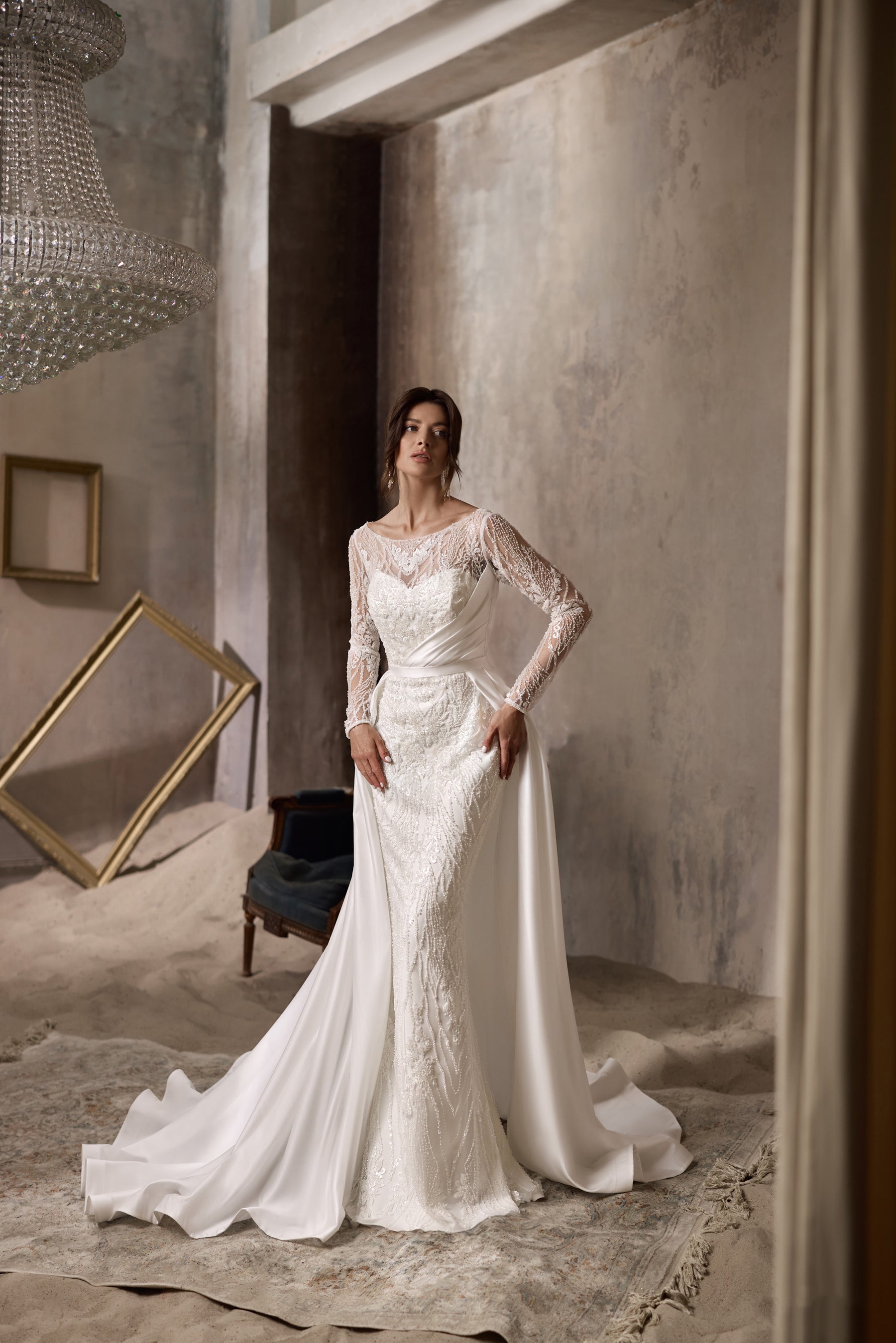 Ivory lace sheath wedding dress shown with a detachable satin overskirt and long train