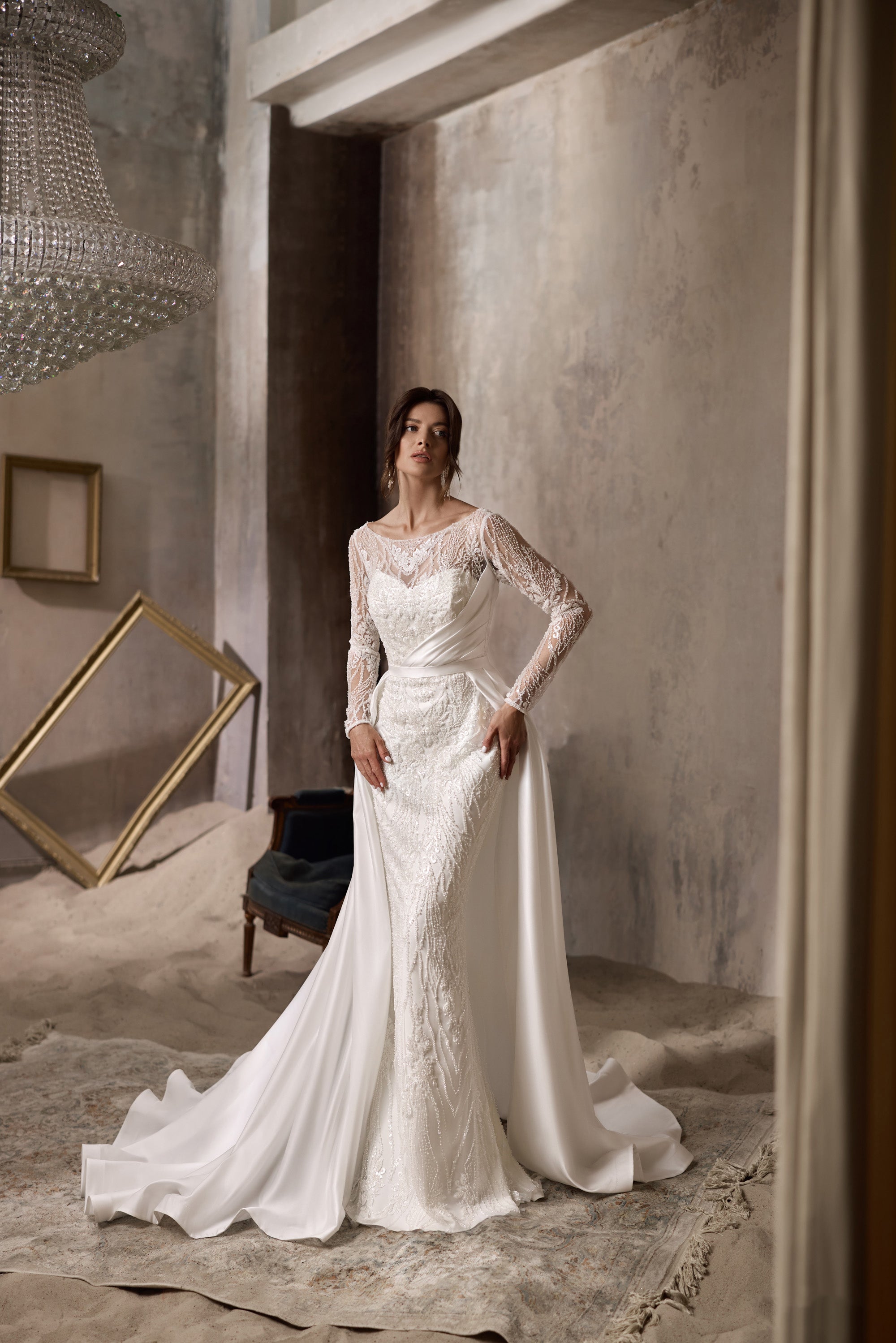 Ivory lace sheath wedding dress shown with a detachable satin overskirt and long train