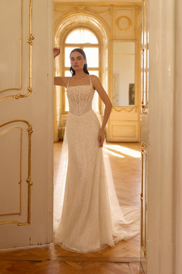 Ivory beaded sheath wedding dress with thin straps, square neckline, and a long trailing train