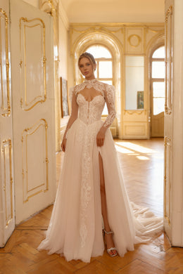 Ivory wedding dress with a high lace neckline, sheer sleeves, beaded bodice, front slit, and train