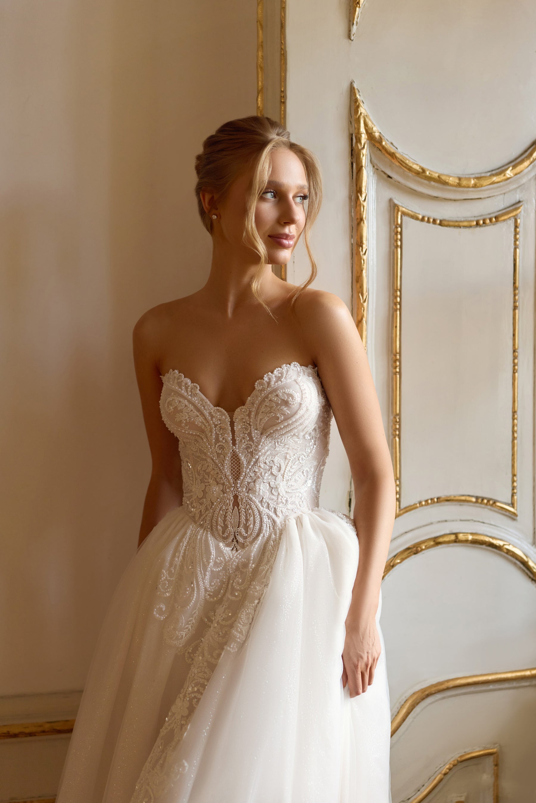 Strapless sweetheart wedding dress with a beaded lace bodice and full sparkling A-line skirt
