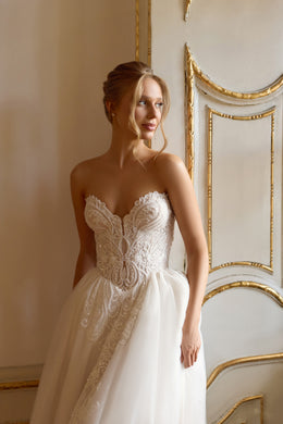 Strapless sweetheart wedding dress with a beaded lace bodice and full sparkling A-line skirt