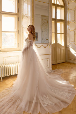 Ivory wedding dress with a full tulle skirt, floral lace detailing, off-the-shoulder sleeves, and a long train