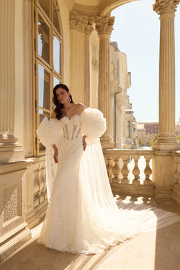 Ivory mermaid wedding dress with floral puff sleeves, beaded bodice, and sweeping train