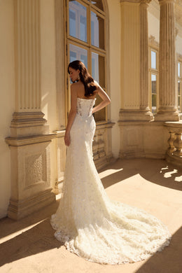 Embellished fitted back and long train on an ivory mermaid wedding dress