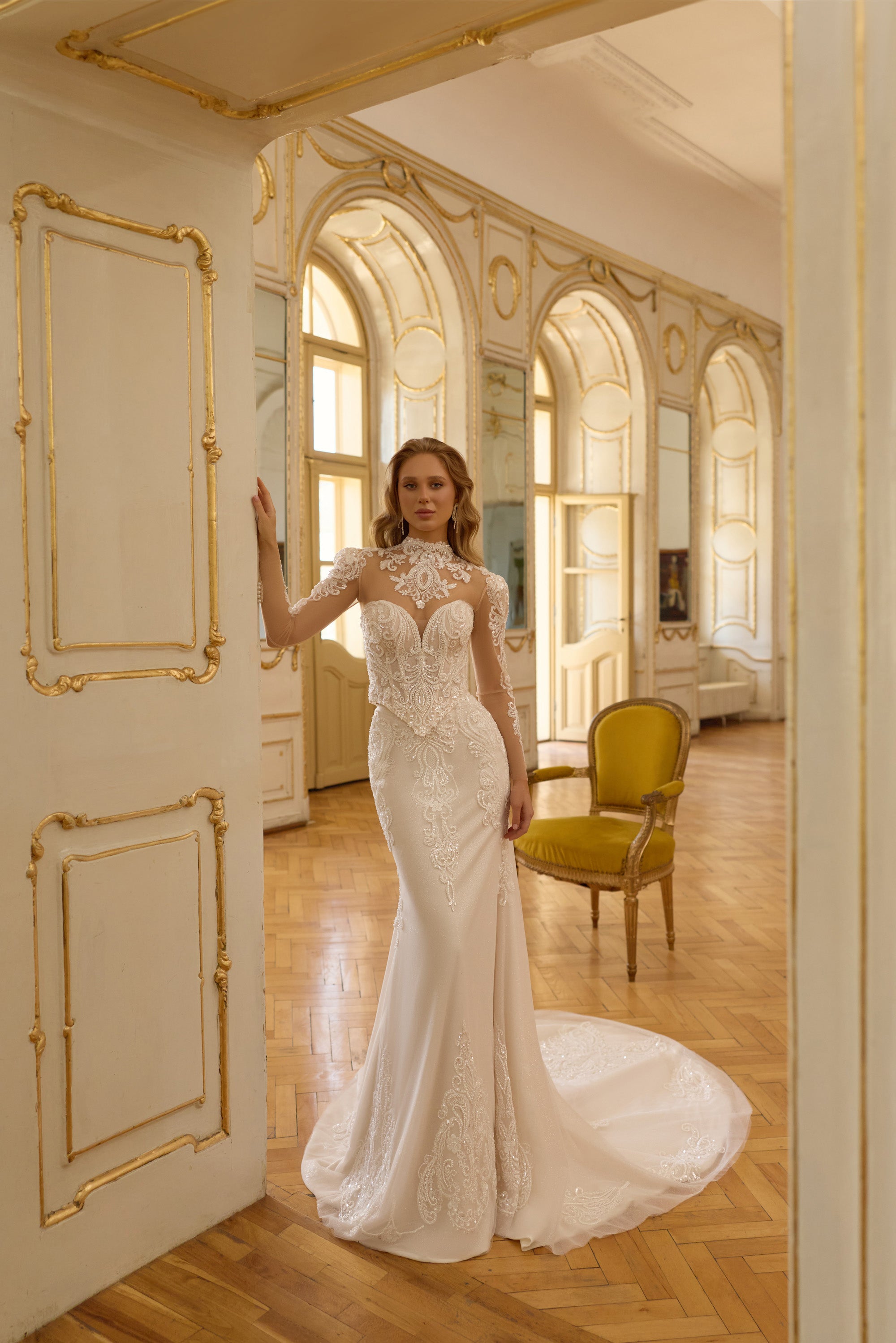 Ivory mermaid wedding dress with illusion high neckline, long lace sleeves, and a sweeping train