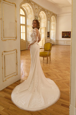Lace long-sleeve wedding dress with a fitted back, mermaid silhouette, and floral train details