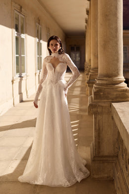 Ivory wedding dress with a sheer lace high neckline, fitted bodice, long sleeves, and a full A-line skirt