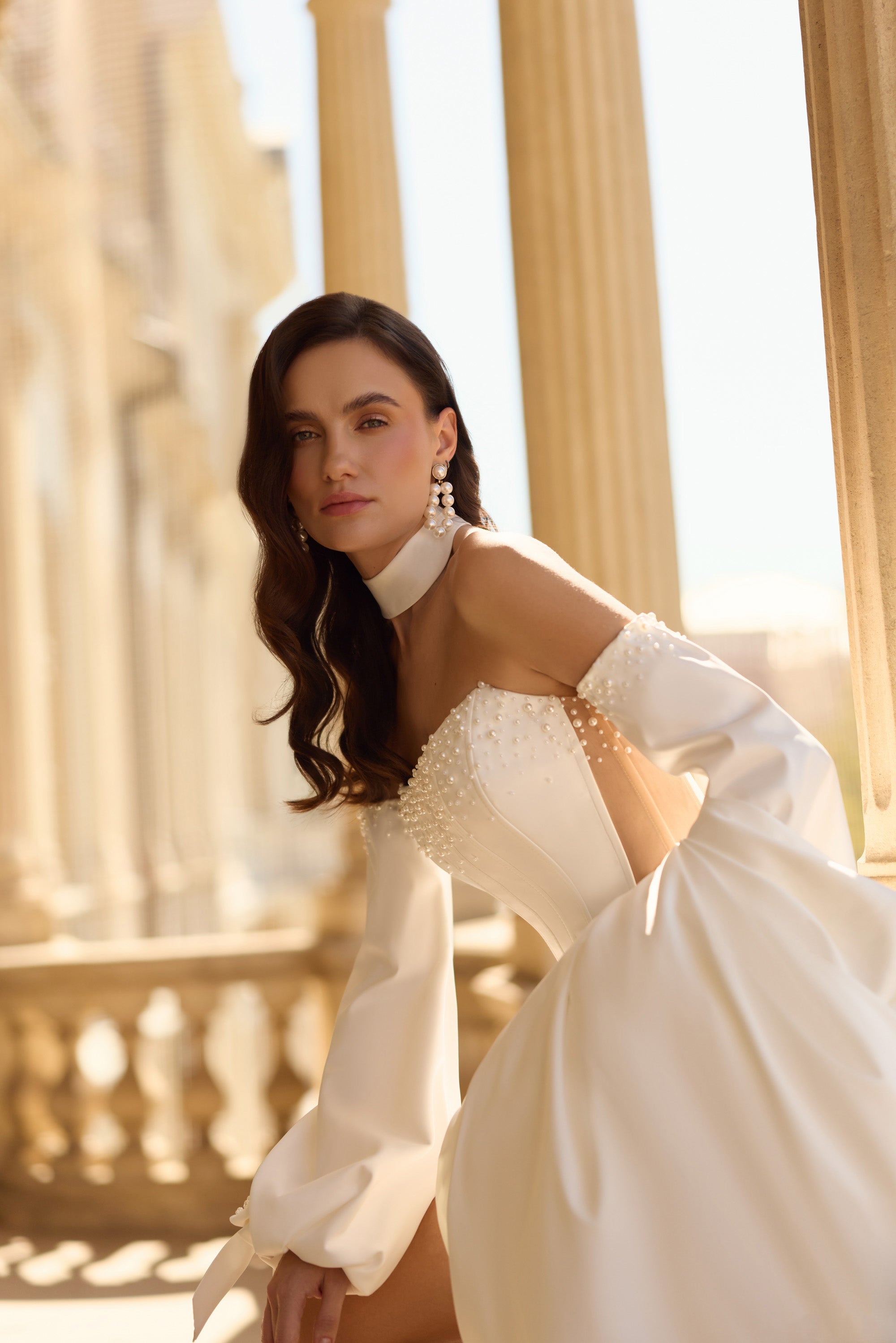 Ivory wedding dress with pearl-embellished corset, high collar, and off-shoulder puff sleeves