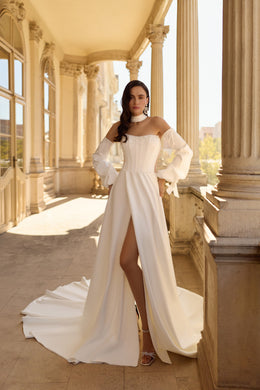Ivory wedding dress with pearl corset, off-shoulder sleeves, thigh-high slit, and sweeping train